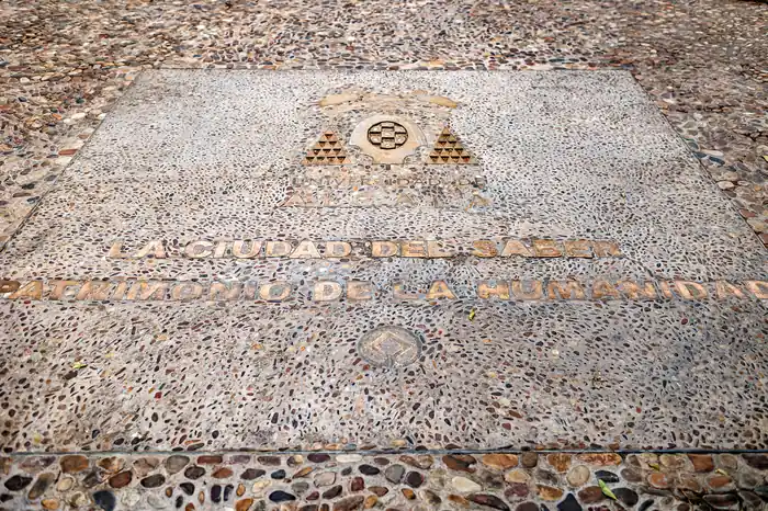 Detalle de la inscripción «La ciudad del saber · Patrimonio de la Humanidad» en el pavimento del patio